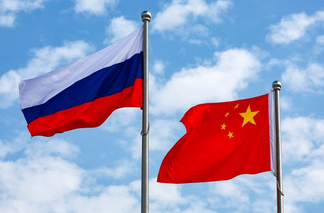Chinese and Russian flags fly at an airport before a ceremony to welcome Russian President Vladimir Putin, who arrives to attend the Shanghai Cooperation Organisation (SCO) summit in Tianjin, China August 31, 2025. Sputnik/Vladimir Smirnov/Pool via REUTERS/File Photo
