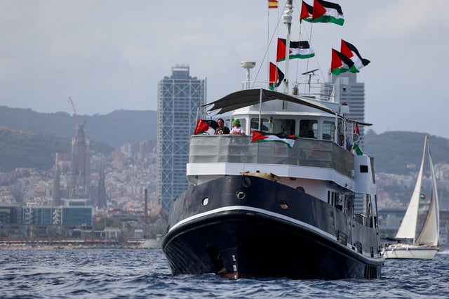 Swedish activist Greta Thunberg departs with other activists on the Global Sumud Flotilla, a humanitarian expedition to Gaza, from the port of Barcelona, Spain August 31, 2025. The Sagrada Familia is seen in the background. REUTERS/Nacho Doce/File Photo