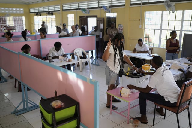 A voter casts her ballot during general elections in Georgetown, Guyana, Monday, Sept. 1, 2025. (AP Photo/Matias Delacroix)