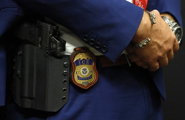A detail view of the badge worn by Matthew Elliston, deputy assistant director of field operations at ICE headquarters in Washington. U.S. Immigration and Customs Enforcement (ICE) hold a major hiring event on August 26, 2025 in Arlington, Texas. The federal immigration agency is ramping up recruiting efforts nationwide.