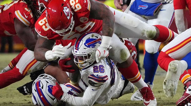 Jan 26, 2025; Kansas City, MO, USA; Kansas City Chiefs defensive tackle Mike Pennel Jr. (69) makes a tackle on Buffalo Bills running back Ty Johnson (26) during the second half in the AFC Championship game at GEHA Field at Arrowhead Stadium. Mandatory Credit: Denny Medley-Imagn Images