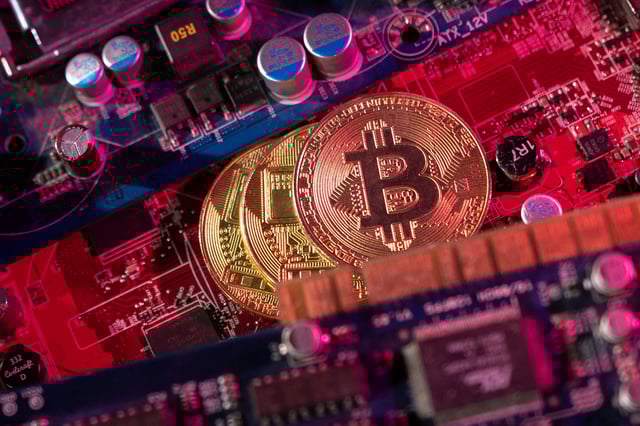 Representations of cryptocurrency Bitcoin are placed on a PC motherboard in this illustration taken June 16, 2023. REUTERS/Dado Ruvic/Illustration/File Photo