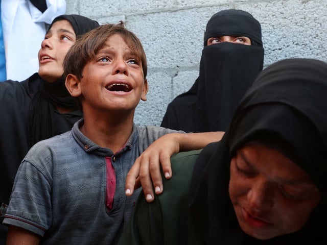 Mourners react during the funeral of Palestinians killed by Israeli fire while trying to receive aid on Sunday, according to medics, at Nasser Hospital in Khan Younis, southern Gaza Strip, September 1, 2025. REUTERS/Ramadan Abed