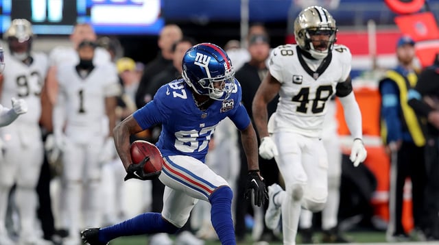 Dec 8, 2024; East Rutherford, New Jersey, USA; New York Giants wide receiver Ihmir Smith-Marsette (87) runs with the ball against New Orleans Saints safety J.T. Gray (48) during the fourth quarter at MetLife Stadium. Mandatory Credit: Brad Penner-Imagn Images