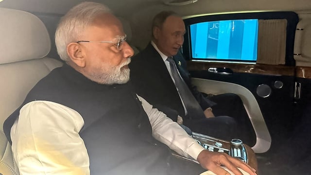 Indian Prime Minister Narendra Modi (L) and Russia's President Vladimir Putin leaving together in a car for the venue of their bilateral meeting after attending the SCO Summit in Tianjin. 