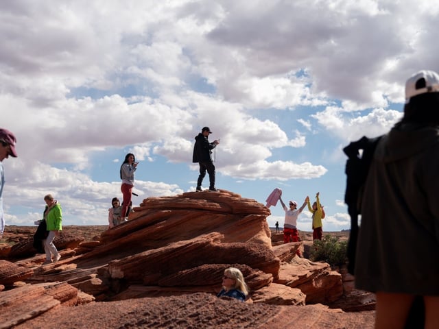 Visitors at Horseshoe Bend near Page, Arizona, US, on Wednesday, May 14, 2025. According to data from the World Travel & Tourism Council (WTTC), shared exclusively with Bloomberg, the country is set to lose $12.5 billion in travel revenue in 2025, with visitor spending estimated to fall under $169 billion by year's end. Photographer: Stefani Reynolds/Bloomberg