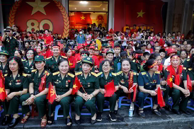 People gather as they wait to watch a parade marking Vietnam's 80th National Day anniversary, at a street in Hanoi, Vietnam, September 2, 2025. Luong Thai Linh/Pool via REUTERS