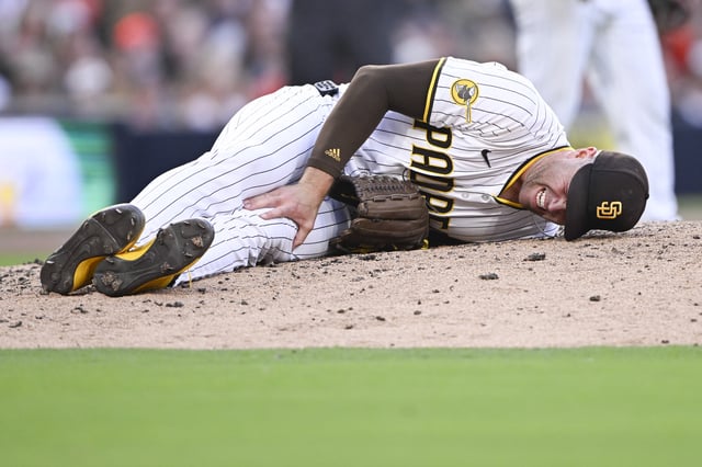 Sep 1, 2025; San Diego, California, USA; San Diego Padres relief pitcher Jason Adam (40) lies on the ground during the seventh inning against the Baltimore Orioles at Petco Park. Adam was taken away in a cart after the play. Mandatory Credit: Denis Poroy-Imagn Images