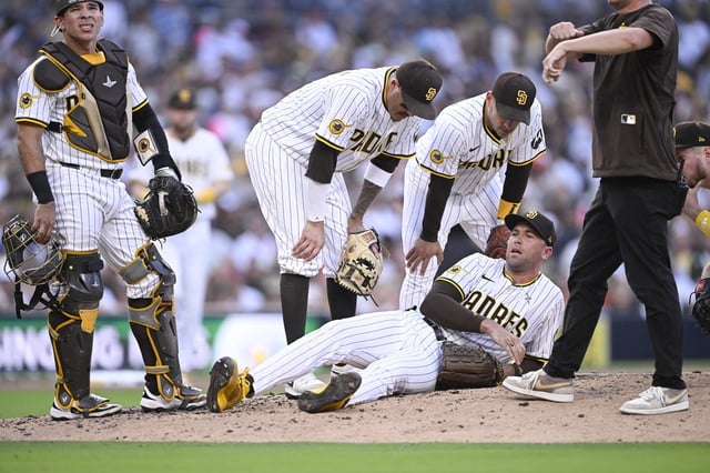 Sep 1, 2025; San Diego, California, USA; San Diego Padres relief pitcher Jason Adam (40) lies on the ground during the seventh inning against the Baltimore Orioles at Petco Park. Adam was taken away in a cart after the play. Mandatory Credit: Denis Poroy-Imagn Images