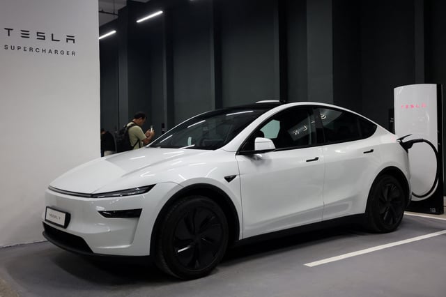A Tesla Model Y is parked at a charging station in New Delhi, India, August 11, 2025. REUTERS/Bhawika Chhabra/File Photo