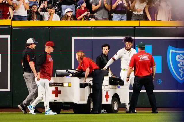 Sep 1, 2025; Phoenix, Arizona, USA; Arizona Diamondbacks outfielder Lourdes Gurriel Jr. (12) is loaded on a cart after colliding with Arizona Diamondbacks centerfielder Blaze Alexander (9) in the outfield in the sixth inning during the game between the Texas Rangers and Arizona Diamondbacks at Chase Field. Mandatory Credit: Arianna Grainey-Imagn Images