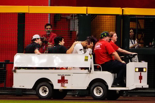 Sep 1, 2025; Phoenix, Arizona, USA; Arizona Diamondbacks outfielder Lourdes Gurriel Jr. (12) is taken off by cart after a collision in the outfield in the sixth inning during the game between the Texas Rangers and Arizona Diamondbacks at Chase Field. Mandatory Credit: Arianna Grainey-Imagn Images