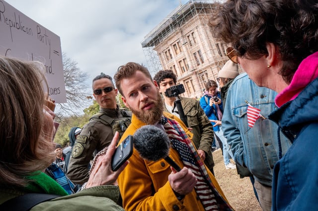 InfoWars host Owen Shroyer questions demonstrators protesting against U.S. President Donald Trump during the "Not My President's Day" demonstration at the Texas State Capitol on February 17, 2025 in Austin, Texas.