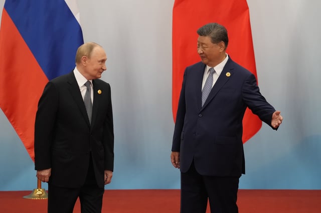 Chinese President Xi jinping (R) shows the way to Russian President Vladimir Putin during the Shanghai Cooperation Organization (SCO) Summit on September 1, 2025 in Tianjin, China.