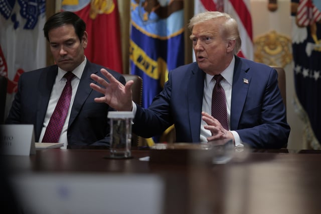 Secretary of State Marco Rubio (L) listens to Donald Trump in the Cabinet Room of the White House on August 26, 2025 in Washington, DC.