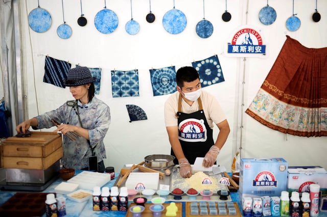 Chinese participants of the Yogurt Festival prepare a rice cake next to Chinese yogurt in the village of Momchilovtsi, Bulgaria, August 29, 2025. REUTERS/Spasiyana Sergieva