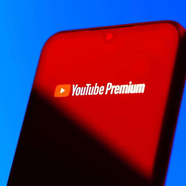 Smartphone on surface showing Youtube Premium logo
