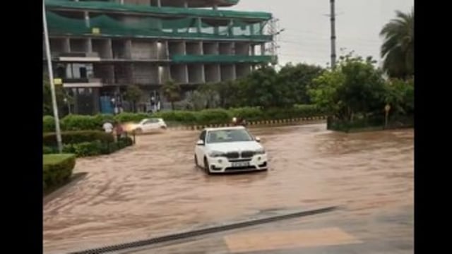 Luxury cars were stranded outside a Gurgaon society gate after heavy rainfall caused severe waterlogging.
