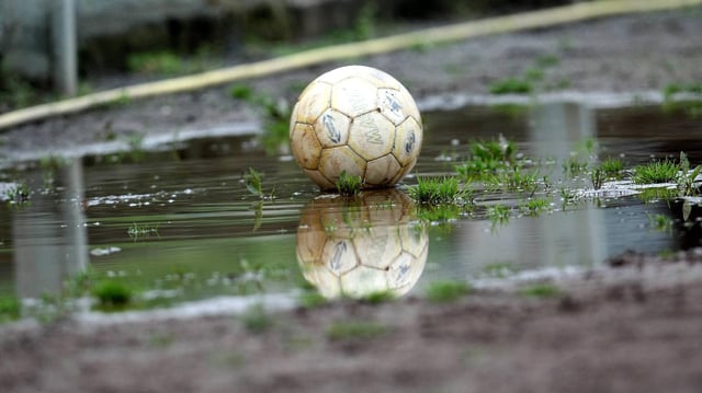Ball liegt in Pfütze