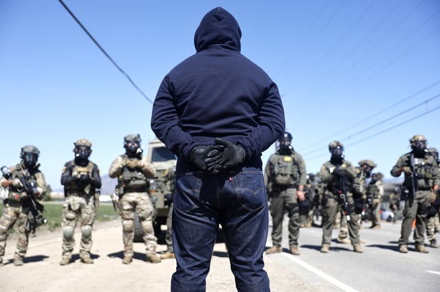 Federal agents block people protesting an ICE immigration raid at a nearby licensed cannabis farm on July 10, 2025 near Camarillo, California. (Photo by Mario Tama/Getty Images)