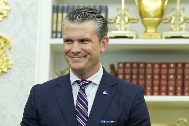 Defense Secretary Pete Hegseth listens as President Donald Trump speaks during an event signing a proclamation honoring the fourth anniversary of the attack at Abbey Gate in Afghanistan, in the Oval Office of the White House, Monday, Aug. 25, 2025, in Washington. (AP Photo/Alex Brandon)
