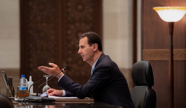 Syria's President Bashar al-Assad speaks as he meets with the Syrian cabinet in Damascus, Syria in this handout picture released by Sana on March 30, 2021. SANA/Handout via REUTERS/ File Photo