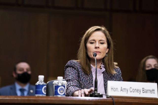 Amy Coney Barrett tests her microphone during a confirmation hearing before the Senate Judiciary Committee, Wednesday, Oct. 14, 2020, on Capitol Hill in Washington.