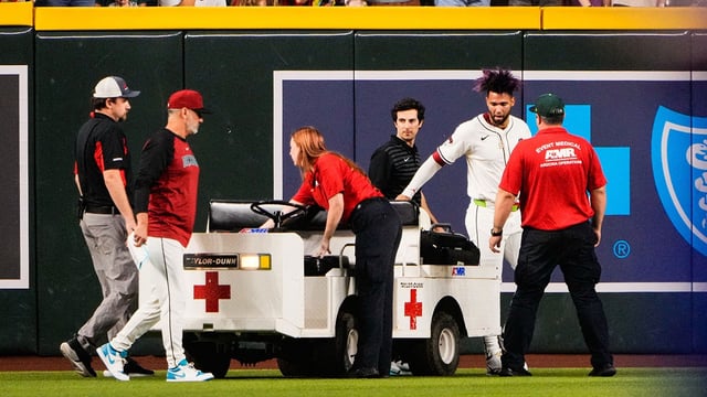 Sep 1, 2025; Phoenix, Arizona, USA; Arizona Diamondbacks outfielder Lourdes Gurriel Jr. (12) is loaded on a cart after colliding with Arizona Diamondbacks centerfielder Blaze Alexander (9) in the outfield in the sixth inning during the game between the Texas Rangers and Arizona Diamondbacks at Chase Field. Mandatory Credit: Arianna Grainey-Imagn Images