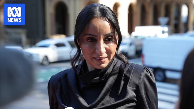 Antoinette Lattouf in a black top, on a CBD street, speaking into a micrphone.