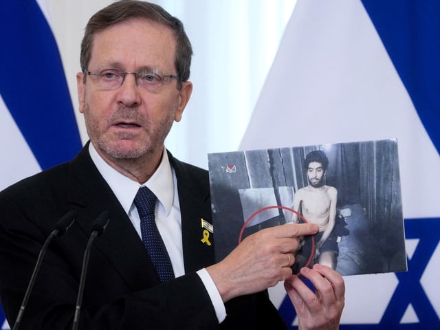 FILE PHOTO: Israeli President Isaac Herzog shows a photo Israeli man Evyatar David, who is held hostage by Hamas, as he speaks during a press conference with Latvian President Edgars Rinkevics in Riga, Latvia August 5, 2025. REUTERS/Ints Kalnins/File Photo