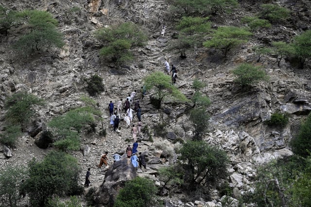 Residents from surrounding towns and villages climb as they try to reach the quake-hit region to assist survivors after Sunday night's powerful 6.0-magnitude earthquake that struck several provinces, in the Nurgol district, Kunar province, eastern Afghanistan, Tuesday, Sept. 2, 2025. (AP Photo/Nava Jamshidi)