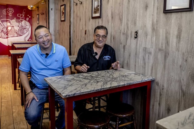 Norris Song, left, and Steven Lee, new co-owners of Chinatown’s Sam Wo restaurant, laugh during an interview with the Chronicle in San Francisco on Tuesday, Sept. 2, 2025.