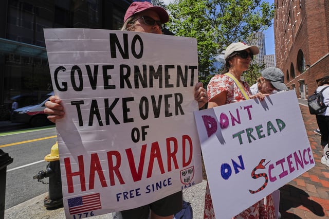 Protestors gather outside the Moakley Federal Courthouse, where Harvard University appeared to challenge $2.6 billion in funding cuts by the Trump administration, Monday, July 21, 2025, in Boston.