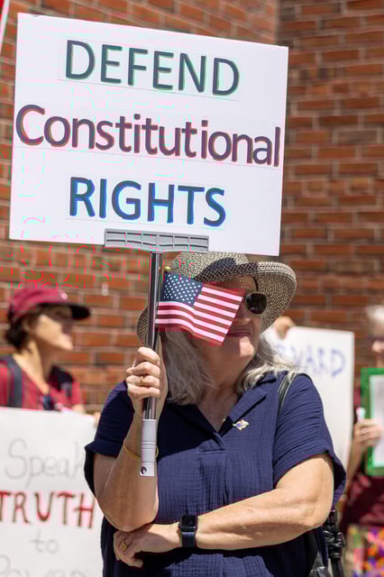 BOSTON, MASSACHUSETTS - JULY 21: A protester holds a sign outside the John Joseph Moakley United States Courthouse on July 21, 2025 in Boston, Massachusetts. Lawyers for Harvard University argued in federal court on Monday that the federal government's freeze of more than $2 billion in grants and contracts is illegal and should be reversed. (Photo by Scott Eisen/Getty Images)