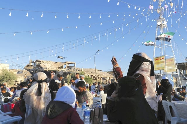 Syrians who fled their homes during the country's civil war  gather to celebrate their return to Arbeen, Syria, Aug. 4.