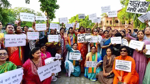 BJP women wing supporters in Dehradun holding placards protest over alleged remarks about PM Modi and his late mother during Congress's 'Voter Adhikar Yatra' in Bihar
