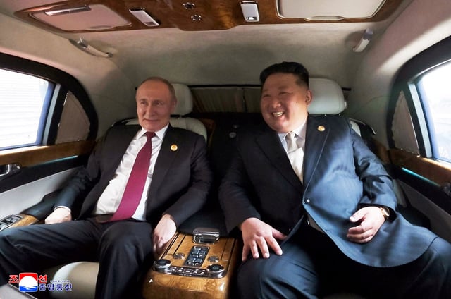Russian President Vladimir Putin and North Korean leader Kim Jong Un sit in a vehicle during their visit to Beijing to attend China's commemoration of the 80th anniversary of the end of World War Two, in Beijing on September 3, 2025.