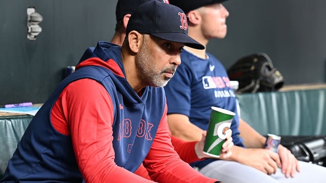 Aug 26, 2025; Baltimore, Maryland, USA; Boston Red Sox manager Alex Cora (13) sits in the dugout before the game between the Baltimore Orioles and the Boston Red Sox at Oriole Park at Camden Yards. Mandatory Credit: James A. Pittman-Imagn Images.