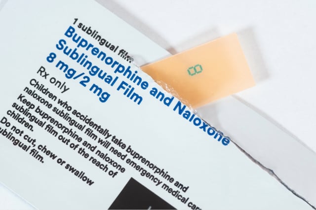 A close-up shot of a box for a medication containing buprenorphine and naloxone sublingual film.