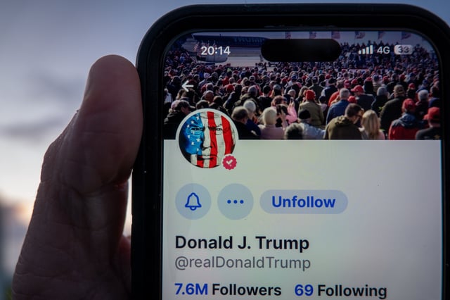 A smartphone screen displays an image of Donald Trump on his Truth Social app on August 15 2024.
