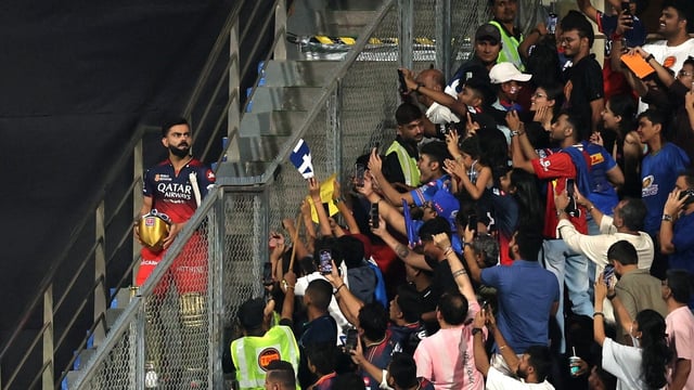 Fans at the Wankhede Stadium reach out towards Virat Kohli.