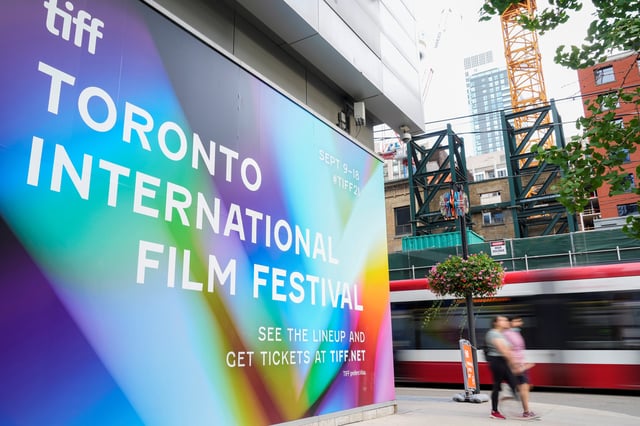 People walk past a Toronto International Film Festival (TIFF) sign in Toronto, Canada, September 9, 2021. REUTERS/Mark Blinch/ File Photo