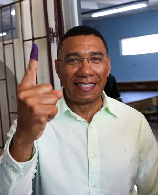 Jamaica's Prime Minister Andrew Holness shows his ink-stained finger after casting his vote in the general election, in Kingston, Jamaica September 3, 2025. REUTERS/Gilbert Bellamy