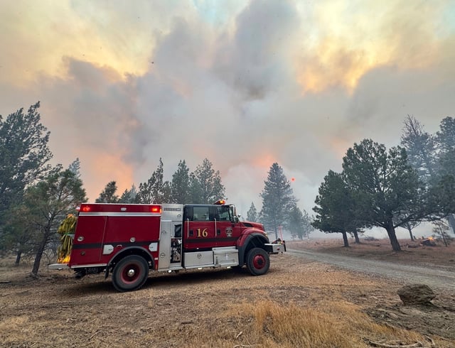 This photo provided by Deschutes County Sheriff's Office shows crews battling the Flat Fire in central Oregon, on Sunday, Aug. 24, 2025. (Deschutes County Sheriff's Office via AP)