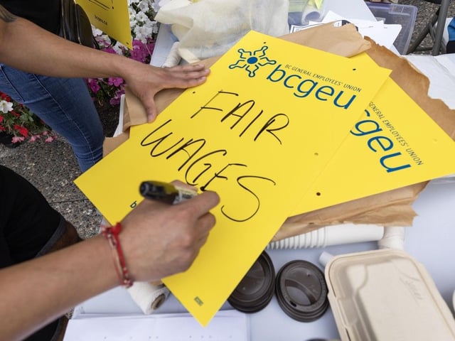 Sign making on the BCGEU picket line at an ICBC office in Surrey on Sept. 2, 2025.
