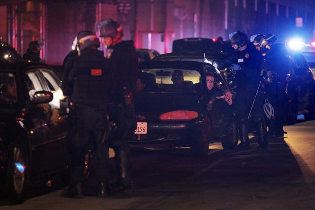 CHP officers process several people detained following a large sideshow event in Oakland in 2014.