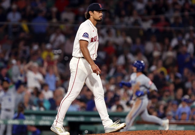 Boston, MA: Boston Red Sox relief pitcher Jordan Hicks is pictured as the Royals Jonathan India rounds the bases in the backround following his seventh inning three run home run. (Jim Davis/Boston Herald).