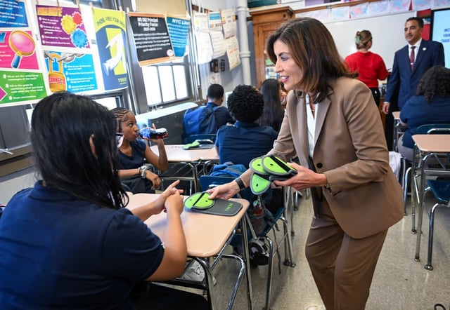 Gov. Kathy Hochul highlights distraction-free schooling by showing students new Yondr cell phone pouches at M.S. 582, The Magnet School for Multimedia Technology and Urban Planning, on Thursday, Sept. 4, 2025. (Susan Watts / Office of Governor Kathy Hochul)