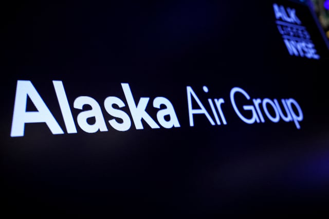 A screen displays the logo of Alaska Air Group on the floor at the New York Stock Exchange (NYSE) in New York City, U.S., December 4, 2023.  REUTERS/Brendan McDermid/File Photo