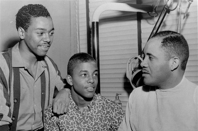 Joseph McNeil, left, stands next to Ezell Blair, Jr., center, student leader in the original lunch counter sit-in, as they discuss legal aspects of anti-segregation with Dr. George C. Simkins, right, a Greensboro dentist and local NAACP leader, in Greensboro, North Carolina, April 20, 1960.